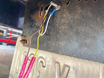 new LED lights installed to a bass boat trailer with nuts and shrink wrap tubing over the wiring harness