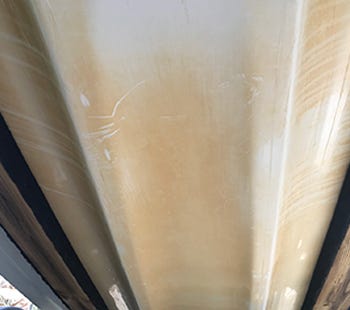 Bottom of a boat hull with scum stains