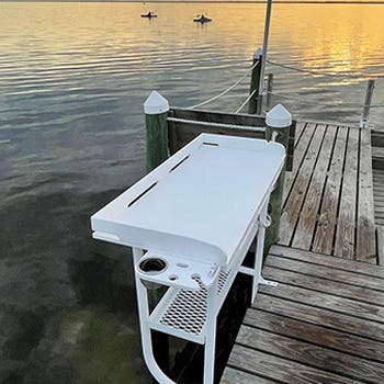 Overhang fillet table installed to a dock for convenient fishing activities