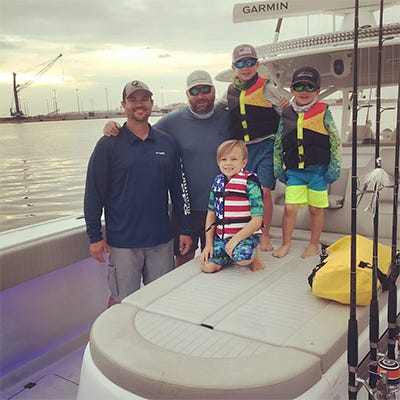 Family picture with sons on a boat