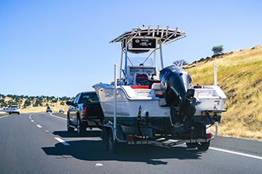 Center Console boat getting towed behind a pickup truck