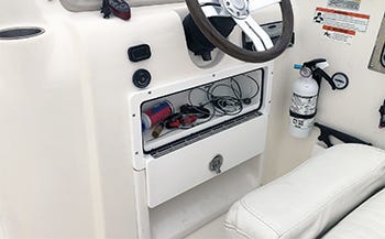 custom built glove box installed under the helm for convenient storage