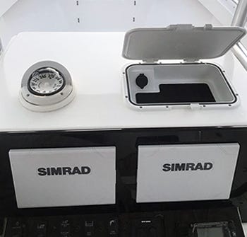 Storage and phone charger box installed to the top of a center console helm to maximize dry storage