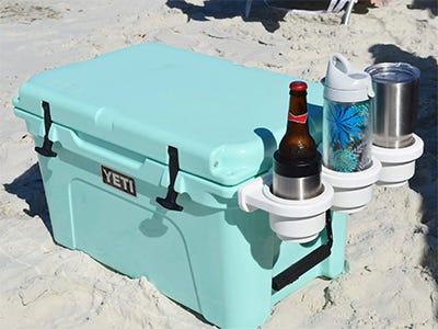 drink holder accessory attached to a Yeti cooler at the beach