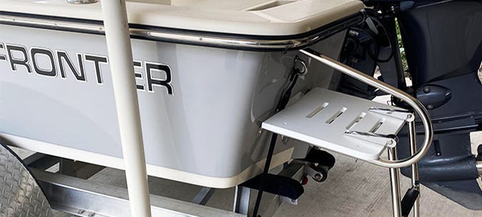 Side view of an installed swim platform on the back of a frontier center console