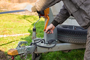 Boater working on boat trailer winch