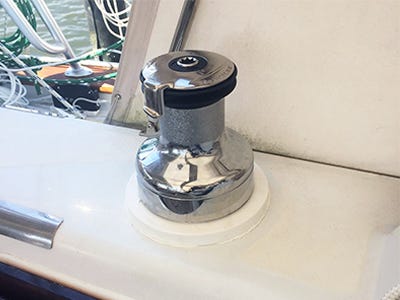 Starboard trim ring mounted around boat windlass