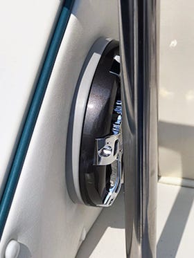 Starboard trim plate mounted behind boat speaker