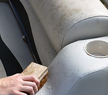 cleaning the vinyl seats on a deck boat with vinyl cleaner