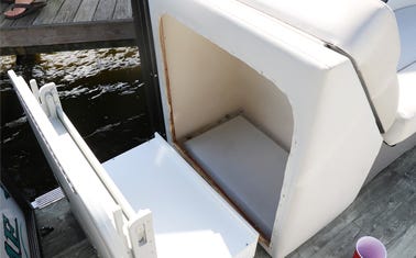 storage box solution being installed into a pontoon boat for convenient storage and table use