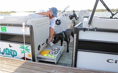 dog enjoying the benefits of the pontoon folding unit with dog bowl drawer