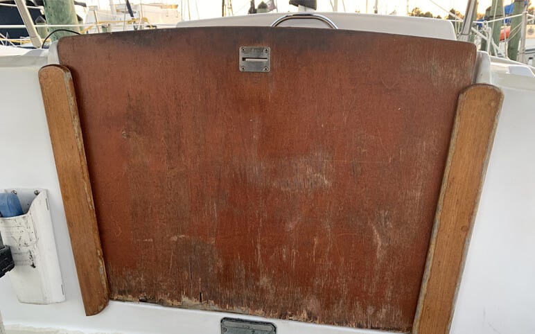 Worn, original teak companionway door on a sailboat